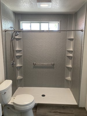 Vincent-Bathroom Remodel - Vince needed a roll-in disability shower for his grandson. A previous contractor had started the job but failed to finish it. We replaced the valves and relocated the Shower drain to the middle to optimize water drainage, then we installed seamless shower walls that require No Maintenance with 2 color matching tower caddies in the corners for storage. We patched and textured the drywall and painted then installed a wall mounted sink. We didn't change the flooring or the baseboards but already you can see the work that was done is a huge improvement! Vincent-Bathroom Remodel - Vince needed a roll-in disability shower for his grandson. A previous contractor had started the job but failed to finish it. We replaced the valves and relocated the Shower drain to the middle to optimize water drainage, then we installed seamless shower walls that require No Maintenance with 2 color matching tower caddies in the corners for storage. We patched and textured the drywall and painted then installed a wall mounted sink. We didn't change the flooring or the baseboards but already you can see the work that was done is a huge improvement!