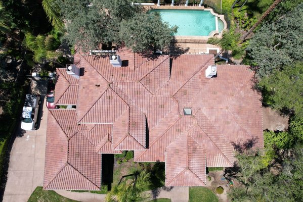 Spanish Style Tile Roof Replacement - One of our beautiful Spanish tile roof replacements completed with a stunning red making the home pop! The homeowner was ready to get rid of their outdated and damaged tiles to make their home safe all year round.