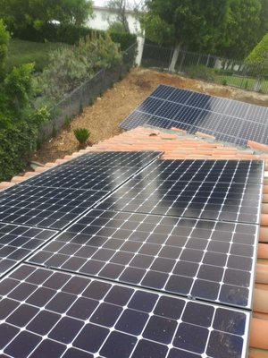 Ground Mount and Rooftop Solar Installation - The 20-year old roof required careful attention. The homeowner carefully considered between a ground mount and other rooftop options to offset $500 monthly electrical bills. The homeowner found it within their best interest to move forward with both options. The complete Solar system installation consisted of 36 370 watt LG panels with microinverters. Ground Mount and Rooftop Solar Installation - The 20-year old roof required careful attention. The homeowner carefully considered between a ground mount and other rooftop options to offset $500 monthly electrical bills. The homeowner found it within their best interest to move forward with both options. The complete Solar system installation consisted of 36 370 watt LG panels with microinverters.