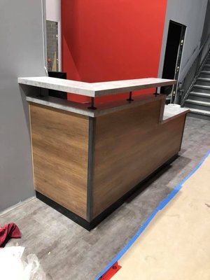 Reception Desk for Slo-Pitch Headquarter Office - Ontario - This custom-built reception desk, designed for the SPN office in Ontario, exemplifies our commitment to quality and design excellence.

Features of the Desk:

- Sleek Modern Design: The clean lines and modern aesthetic make it an impressive centerpiece for the office lobby.
- Premium Materials: Crafted with a combination of wood tones and durable surfaces, this desk seamlessly blends style with functionality.
- Ergonomic and Practical: Designed with both the user and visitors in mind, the desk provides ample workspace while maintaining a welcoming look.

We worked closely with the SPN team to ensure every detail met their expectations, delivering a solution that complements their office environment.

Let us bring your vision to life with our custom furniture designs. Reach out to us for your next project! Call Now!