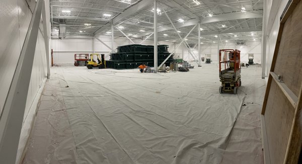 Interior Freezer Warehouse repaint - This was a 70,000 Square foot warehouse we were contacted to do somewhat urgently before the shelves were installed. We started right after all their floors were repaired and finished spraying out this project in 8 days! We blew the dust off of the rafters, covered fire sprinklers, lights and other surfaces not to be painted then painted the ceilings with Sherwin Williams Acrylic Dryfall Extra White and the walls with Sherwin Williams Bondplex! with 5 sprayers running almost constantly we finished right as the new shelves were getting delivered and happy we could get it done for them!