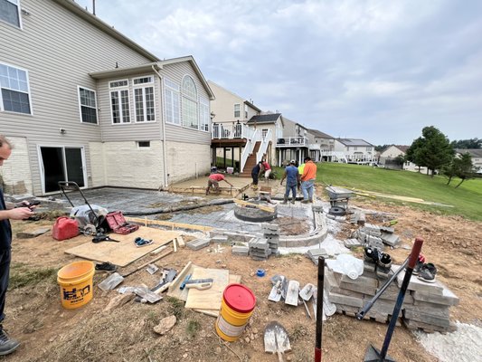 Stamped concrete patio and firepit install - Stamped patio before during after