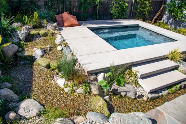 16′ Pondless Waterfalls | Modern Spa & Stream - 16′ Pondless Waterfall - This is a completely custom waterfall that wraps around a modern spa. This client wanted to soften up the harsh edge of the spa. We were able to come right up to the edge with custom rock work and seamlessly blend the modern and natural. 16′ Pondless Waterfalls | Modern Spa & Stream - 16′ Pondless Waterfall - This is a completely custom waterfall that wraps around a modern spa. This client wanted to soften up the harsh edge of the spa. We were able to come right up to the edge with custom rock work and seamlessly blend the modern and natural.
