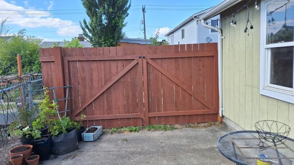 repair & stain the fence - A woman with an interesting last name had her fence gate broken by the wind. It needed to be repaired and stain.