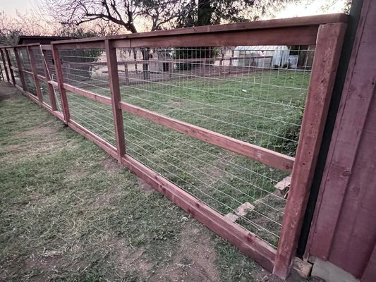 New fence installation - This customer wanted to create (3) separate spaces in her backyard with (2) gates.  She needed separate areas for her Rottweilers, tortoise and puppies.  She also needed the ability to see through all of the fencing, so we decided on using high quality metal welded wire fencing and as always we used coated deck screws and galvanized staples for the metal fencing, because non-coated screws and regular steel staples rust and will leave rust stains on a fence.  This fence was in the shape of a (T) with the shorter section of the "T" being 5 feet tall and the longer section of the "T" being 3 feet tall.