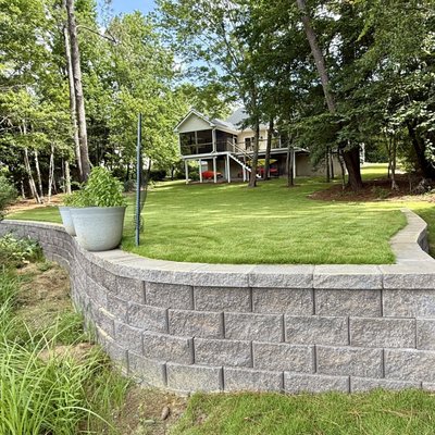 Backyard Renovation Featuring New Drainage and Retaining Wall - A new retaining wall, combined with efficient drainage and irrigation, was added to maximize backyard utility and prevent flooding.