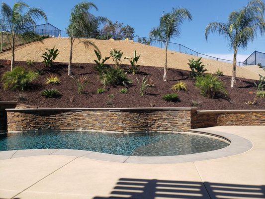 Corona Project. Free form custom pool. - We completed this project in Corona in 2018, the pool included retaining walls, new colored concrete patio and pool deck. Corona Project. Free form custom pool. - We completed this project in Corona in 2018, the pool included retaining walls, new colored concrete patio and pool deck.