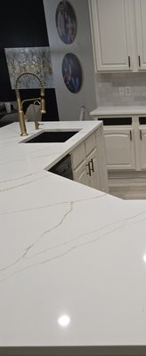 Kitchen Remodeled in Celina Texas - This kitchen remodel features stunning new countertops and backsplashes crafted from premium 3cm Quartz. Known for its durability, low maintenance, and elegant appearance, Quartz offers both beauty and functionality. The 3cm thickness provides a substantial, high-end look while ensuring lasting strength for everyday kitchen use. The seamless integration of the countertop and backsplash creates a clean, modern aesthetic that complements a variety of cabinet and flooring styles. With a non-porous surface, these Quartz surfaces are resistant to stains, scratches, and bacteria—making them a perfect choice for a busy, stylish kitchen.