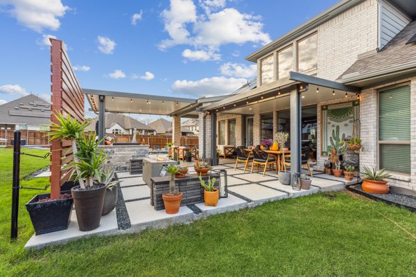 Outdoor Kitchen & Living Area - This project delivered a fully custom outdoor kitchen and living area, transforming an underutilized backyard into a complete alfresco entertaining space. Our team designed and built the entire installation from the ground up, including a custom grill island, covered dining and lounge areas, and a cohesive patio surface that ties the whole space together. Premium outdoor appliances and carefully selected materials were chosen to complement the home's existing style while standing up to year-round Texas conditions. With dedicated seating zones, ample counter space, and shade overhead, this outdoor kitchen functions as a true extension of the home's living area. From design concept and permitting through to the final walkthrough, Allied managed every detail so the homeowners could simply enjoy the result. Outdoor Kitchen & Living Area - This project delivered a fully custom outdoor kitchen and living area, transforming an underutilized backyard into a complete alfresco entertaining space. Our team designed and built the entire installation from the ground up, including a custom grill island, covered dining and lounge areas, and a cohesive patio surface that ties the whole space together. Premium outdoor appliances and carefully selected materials were chosen to complement the home's existing style while standing up to year-round Texas conditions. With dedicated seating zones, ample counter space, and shade overhead, this outdoor kitchen functions as a true extension of the home's living area. From design concept and permitting through to the final walkthrough, Allied managed every detail so the homeowners could simply enjoy the result.
