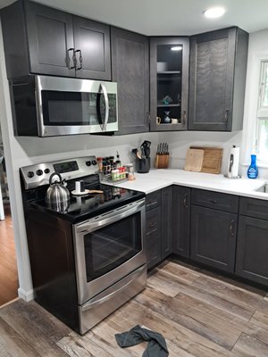 Centerville July 2024- Shaker Cinder Color - This was an interesting project in that while it was a standard U Shaped kitchen the owners wanted us to add a pantry to a wall that we only had 1' of depth to work with. We used 4-42" H x 36" wide Wall cabinets stacked 2 high mounted on a 4" filler strip to create a toe Kick area. It turned out to be a great way to add storage to a small kitchen. We also used the lower left cabinet to create a tip out trash Bin. The owner chose to us "birdcage style" cabinet handles which added a nice finishing touch to the project. We added our signature metal carousels to the base corner cabinets and some rollout shelves to another of the base cabs.  It was a fun project and the owners were great to work with!
