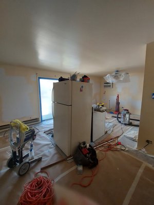Bourbonnais Progress to Completion - When our crew arrived, this Bourbonnais unit's walls were in dire need of new paint. To begin the job, we needed to tape down paper and plastic over the carpet, cabinets, and fixtures to protect them from debris and drips. Then, we moved the appliances so we didn't miss the areas behind them, began to prep by sanding any bumps or scuffs on the walls, and rolled on plenty of primer. Finally, it was time to paint and give this apartment fresh, new life for its next residents!