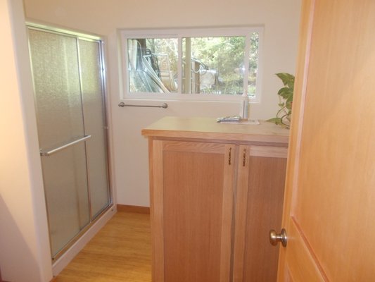 Garage Conversion - Here we converted part of an older garage into a living space, complete with a bathroom, 1 bedroom, a kitchen, and living room. The work consisted of light framing, drywall, painting, and trim carpentry. We also built the cabinets.