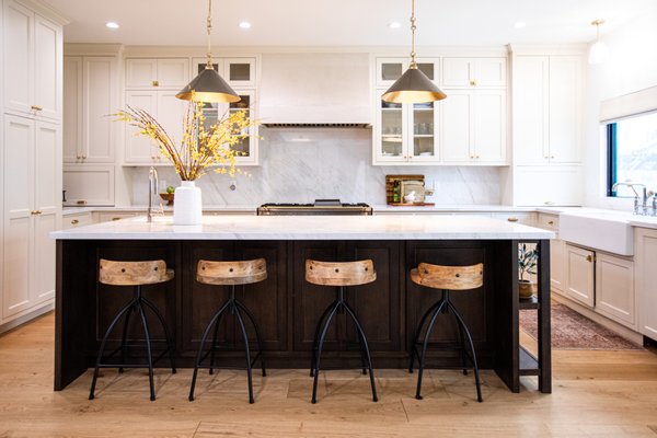 Luxury Kitchen Remodel with a Custom Furniture-Style Island by SB Construction & Remodeling in Encino, CA - "SB Construction & Remodeling recently completed this luxury kitchen remodel in Encino, transforming the heart of the home into a refined, open-concept space where timeless design meets everyday functionality. The existing layout was reimagined to create a kitchen that feels more connected, spacious, and inviting, making it just as suited for daily use as it is for hosting family and guests.
At the center of the design is a custom furniture-style island that anchors the room while providing generous prep space, seating, and built-in storage. Its rich espresso finish creates a beautiful contrast against the surrounding white shaker cabinetry, giving the kitchen depth and visual balance. Natural light fills the space through the oversized window above the farmhouse sink, highlighting the soft tones of the quartz countertops and full-height slab backsplash that extend seamlessly throughout the workspace.
Every element was selected to complement the kitchen's transitional style, from the warm brass hardware and statement pendant lighting to the glass-front cabinets that add dimension without overwhelming the design. A professional-grade range and custom hood establish a striking focal point, while thoughtfully designed cabinetry offers abundant storage that keeps the space organized without sacrificing elegance.
The completed remodel delivers a kitchen that feels sophisticated, welcoming, and built for the way modern families live. If you're planning a custom kitchen renovation, SB Construction & Remodeling creates beautifully crafted spaces tailored to each home's unique style and needs." Luxury Kitchen Remodel with a Custom Furniture-Style Island by SB Construction & Remodeling in Encino, CA - "SB Construction & Remodeling recently completed this luxury kitchen remodel in Encino, transforming the heart of the home into a refined, open-concept space where timeless design meets everyday functionality. The existing layout was reimagined to create a kitchen that feels more connected, spacious, and inviting, making it just as suited for daily use as it is for hosting family and guests.
At the center of the design is a custom furniture-style island that anchors the room while providing generous prep space, seating, and built-in storage. Its rich espresso finish creates a beautiful contrast against the surrounding white shaker cabinetry, giving the kitchen depth and visual balance. Natural light fills the space through the oversized window above the farmhouse sink, highlighting the soft tones of the quartz countertops and full-height slab backsplash that extend seamlessly throughout the workspace.
Every element was selected to complement the kitchen's transitional style, from the warm brass hardware and statement pendant lighting to the glass-front cabinets that add dimension without overwhelming the design. A professional-grade range and custom hood establish a striking focal point, while thoughtfully designed cabinetry offers abundant storage that keeps the space organized without sacrificing elegance.
The completed remodel delivers a kitchen that feels sophisticated, welcoming, and built for the way modern families live. If you're planning a custom kitchen renovation, SB Construction & Remodeling creates beautifully crafted spaces tailored to each home's unique style and needs."