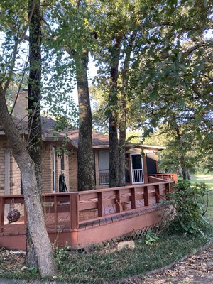Removal Over Deck - This lake house had a deck built around the three oaks pictured above. Our customer instantly knew this was a hazard upon purchasing and had us come remove all three so he could rebuild the deck over the stumps. Each piece had to be carefully lowered by rope to avoid property damage. We worked until well after dark but as always, we aimed for customer satisfaction and didn’t rest until we achieved it. Removal Over Deck - This lake house had a deck built around the three oaks pictured above. Our customer instantly knew this was a hazard upon purchasing and had us come remove all three so he could rebuild the deck over the stumps. Each piece had to be carefully lowered by rope to avoid property damage. We worked until well after dark but as always, we aimed for customer satisfaction and didn’t rest until we achieved it.