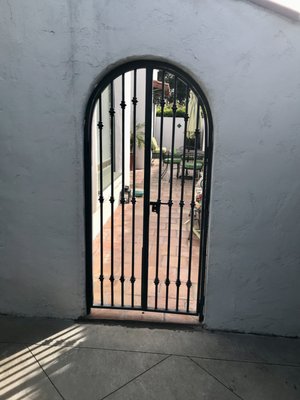 Custom Wrought Iron Gate & Stair Railing – Beverly Hills - This project combines timeless style and function, featuring a wrought iron arched entry gate for added security and a custom interior stair railing designed to complement the home’s elegant architecture. Both pieces were crafted with attention to detail, providing lasting beauty and durability.
