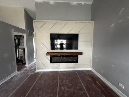 Media accent wall - Completed a custom accent wall project. Installed decorative trim and painted it in the color chosen by the client. Mounted a decorative beam and installed the TV. Built the base for the electric fireplace and installed the fireplace Media accent wall - Completed a custom accent wall project. Installed decorative trim and painted it in the color chosen by the client. Mounted a decorative beam and installed the TV. Built the base for the electric fireplace and installed the fireplace