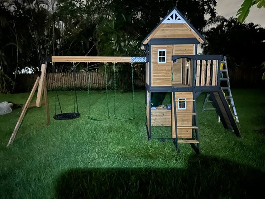 Backyard Wooden Playset Assembly - I fully assembled a multi-functional wooden playset for children, which includes a playhouse, slide, climbing ladder, and three swings — one of which is a round net swing. The structure features a two-level playhouse with windows and a balcony, offering space for both active play and imaginative indoor fun. I ensured the construction was secure and level, making it safe and enjoyable for kids. The entire assembly was done on-site in a backyard setting. Backyard Wooden Playset Assembly - I fully assembled a multi-functional wooden playset for children, which includes a playhouse, slide, climbing ladder, and three swings — one of which is a round net swing. The structure features a two-level playhouse with windows and a balcony, offering space for both active play and imaginative indoor fun. I ensured the construction was secure and level, making it safe and enjoyable for kids. The entire assembly was done on-site in a backyard setting.