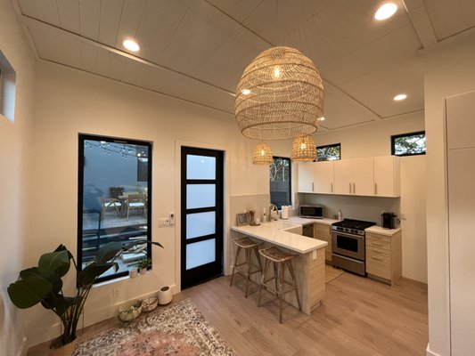Garage Conversion in Venice - This 400 sqft garage conversion into a studio apartment involved a complex system of underpinned foundation, a topping slab with a bathroom depression, grey-water separation system, interior shear walls, highly energy-efficient windows, brand new torch-down roof, level 2 metered EV charger, smooth exterior stucco, and a skylight.
For interior finishes, the owner selected a pine plank ceiling with 2x4s running across, IKEA cabinets, mosaic tile for walls and terazzo tile for floors, and vinyl plank flooring.
Construction activities were taking place on a tight lot in Venice, but the owner was able to fully utilize the backyard area during the entire duration of the project. It took some time to get the building plans through the Coastal Commission, but once construction kicked off, it was a smooth process. We worked together with the owner to ensure that their vision for this ADU was materialized.
If you are looking for help trying to convert or build a brand-new ADU, have questions about any construction phase or inspections, or have any other questions, do not hesitate to give us a call at (323) 640-9149. We will be happy to help. Garage Conversion in Venice - This 400 sqft garage conversion into a studio apartment involved a complex system of underpinned foundation, a topping slab with a bathroom depression, grey-water separation system, interior shear walls, highly energy-efficient windows, brand new torch-down roof, level 2 metered EV charger, smooth exterior stucco, and a skylight.
For interior finishes, the owner selected a pine plank ceiling with 2x4s running across, IKEA cabinets, mosaic tile for walls and terazzo tile for floors, and vinyl plank flooring.
Construction activities were taking place on a tight lot in Venice, but the owner was able to fully utilize the backyard area during the entire duration of the project. It took some time to get the building plans through the Coastal Commission, but once construction kicked off, it was a smooth process. We worked together with the owner to ensure that their vision for this ADU was materialized.
If you are looking for help trying to convert or build a brand-new ADU, have questions about any construction phase or inspections, or have any other questions, do not hesitate to give us a call at (323) 640-9149. We will be happy to help.