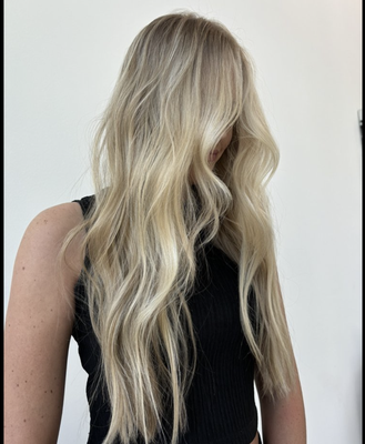 Modern Blonde & Brunette Transformations - Photo 1: Dimensional Blonde Beach Waves
Description: A long, layered cut featuring multi-dimensional blonde highlights, seamlessly blended for a sun-kissed effect. Finished with soft, loose beach waves, this look is perfect for effortless style and natural movement.

Photo 2: Textured Lived-In Brunette Bob
Description: A chic, chin-grazing brunette bob with face-framing layers and tousled, lived-in waves. This cut delivers modern texture, volume, and easy maintenance—ideal for a fresh and versatile everyday style.

Photo 3: Long Layers with Curtain Bangs
Description: A sophisticated long layered hairstyle with soft, face-framing curtain bangs. The dimensional blonde tones add brightness and depth, while feathered layers create movement and a polished, modern finish.