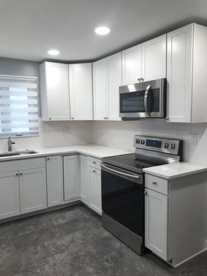 Kitchen remodel - We removed bulk head, added recess lights , reconfigured kitchen layout, installed new cabinetry , backsplash, and flooring . Kitchen remodel - We removed bulk head, added recess lights , reconfigured kitchen layout, installed new cabinetry , backsplash, and flooring .
