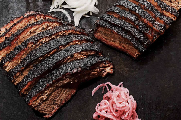 Prime Beef Brisket - Prime Beef Brisket is trimmed and rubbed with our signature Texas-style seasoning and smoked low and slow over hardwood until fork-tender, with a distinguished bark, visible smoke ring, and rich, beefy flavor in every slice.