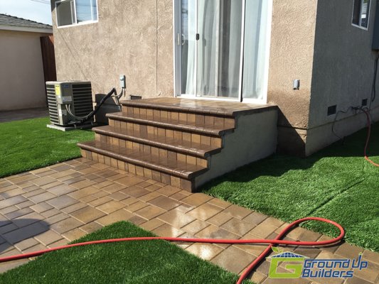 Whittier Pavers and hardscape - We helped create a beautiful back yard for this homeowner in Whittier, CA. We demoed the old concrete, porch area and removed the grass and dirt. In its place we installed Artificial grass, interlocking pavers and loose gravel to give it a more landscaped look will eliminating the need to water the entire back lawn saving the family hundreds of dollars a year in water cost