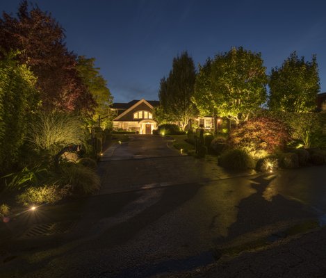 Medina Home - In the beautifully illuminated nightscape of Bellevue, the lighting design strikes a balance between aesthetics and functionality. The residence's warm glow juxtaposes the blue twilight sky of the Northwest, setting a tranquil ambiance. Uplights emphasize the textures of the trees, adding depth to the landscape. Garden lights accentuate the region's diverse plant palette, with a spotlight highlighting an ornamental bridge. The driveway's gradient is illuminated for safe navigation, emphasizing Northwest Outdoor Lighting's commitment to sophistication and elegance.

You can view more of our large portfolio on our website.