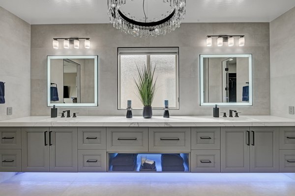 Bathroom Remodel 2025 - This modern luxury bathroom remodel features clean lines, cool tones, and elevated elegance. Designed for both function and flair, this space showcases a double-sink vanity with under-cabinet LED lighting, providing a soft ambient glow that adds a spa-like atmosphere.