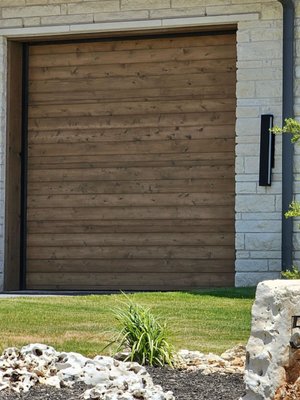 Horizontal Shiplap Garage Door - Custom built with a wood overlay and stained. Horizontal Shiplap Garage Door - Custom built with a wood overlay and stained.