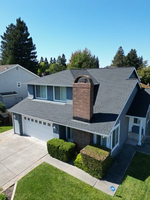 Napa Roof Replacement - Complete Shingle Upgrade - This Napa roof replacement project involved a complete tear-off and installation of a modern asphalt shingle system on a two-story residential home. The existing roof had reached the end of its service life and was showing signs of wear.

We installed high-quality architectural shingles in a sophisticated gray tone that complements the home's exterior siding and brick accents. Our team ensured proper ventilation and installed new flashing around all penetrations and roof edges for maximum weather protection.

The new roofing system enhances this Napa home's curb appeal while providing decades of reliable protection. The upgraded shingles offer superior wind resistance and warranty coverage, giving the homeowners peace of mind.

Looking for professional roof replacement in Napa? Contact us for a free consultation and estimate.
