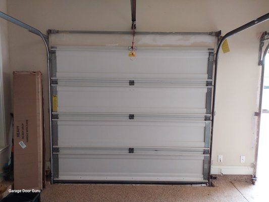 Torsion spring conversion - In these photos you will see a before and after photo of the same door. The First photo shows what a wayne dalton spring system looks like with a broken spring, you cant see it. The second photo shows a conversion we did to the door, using a longer lifecycle spring and a standard torsion spring assembly. These conversions tend to last much longer than the OEM system, and we keep these parts on the trucks at all times. So if your system breaks again, repairs can be made on the same visit! Torsion spring conversion - In these photos you will see a before and after photo of the same door. The First photo shows what a wayne dalton spring system looks like with a broken spring, you cant see it. The second photo shows a conversion we did to the door, using a longer lifecycle spring and a standard torsion spring assembly. These conversions tend to last much longer than the OEM system, and we keep these parts on the trucks at all times. So if your system breaks again, repairs can be made on the same visit!