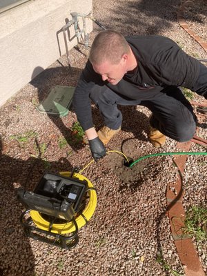 Video Camera Inspection revealed root ball clog. Hydrojet Service Cleared Root ball clog! - Weekend Energency Hydrojet Service! Video Inspection of main line drain revealed heavy root ball in line. After snaking main line to poke hole in roots to retain flow to main drain, we had to explain to customer that he needed a hydrojet service or the root ball would clog up sewer pipe again soon and not let waste leave pipe until the hydrojet service was performed and root ball removed. Customer agreed to schedule hydrojet for the next morning. Hydrojet removed root ball clogging system. Recommended to eventually dig up line and replace area where roots will continue to grow back in over time. 
Need an Emergency Plumbing Service? 
Call Us! (602) 369-0958