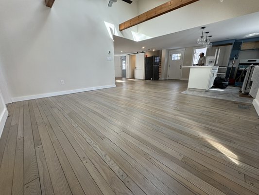 Custom Floor Staining 2026 - This Kitchen & Dining room area were heavily worn, we sanded the floors down, and applied a custom colored blue-gray stain, and 3 coats of commercial grade satin finish.