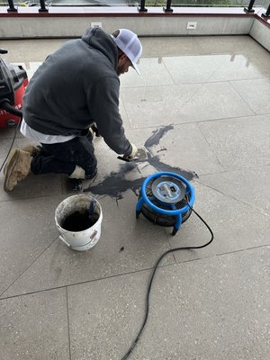 San Clemente porcelain tile restoration - San Clemente porcelain tile restoration Porcelain tile should not be sealed unless specified by the manufacturer. In this San Clemente project, trapped moisture from an improper sealer caused persistent haze and efflorescence at the drain. By fully stripping the sealer, repairing grout, and deep cleaning the surface, we restored proper vapor transmission—and the issue has stopped completely.