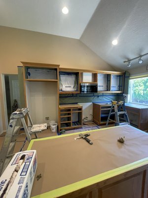 High Quality Cabinet Repainting - The kitchen cabinets and bathroom vanities were showing significant wear with their original wood finish. To refresh the space, the owner chose a bright white for both the cabinets and vanities, while the island was painted a sage green accent for added character. The semi-gloss sheen not only enhances the look but also provides durable protection and makes cleaning easier.