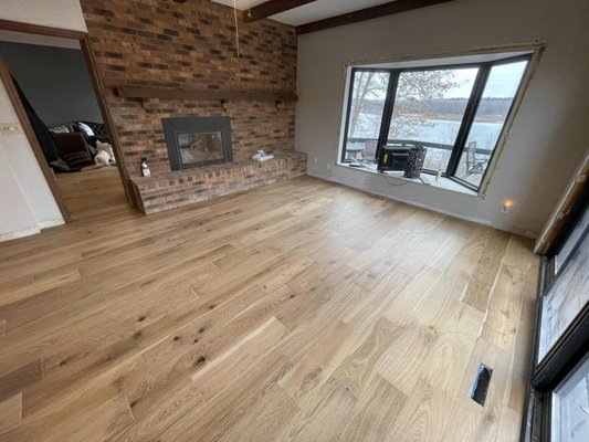 Hardwood Flooring Installation - AMAZING turnout for this awesome Hardwood Flooring project. This is not your “floating floor system.” This is engineered stationed hardwood flooring. We are very detailed in every project we do. We undercut around the fireplace in both rooms and the masonry walls for a perfect smooth looking finish. If you're looking for your next project, please consider our team. We are professional. We are responsive. Our communication is clear. We are well trained and very knowledgeable. Our work is top notch. We are booking for spring and summer exterior projects.