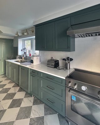 Green Galley Kitchen & Mudroom Remodel in Penn Wynne, PA - What the work involved
The original kitchen had flat blue cabinets, worn beige counters, and yellowed floor tile, with a cluttered back entry closed off behind it. The space was opened up with a new structural beam, and both areas were rebuilt as a single room with new electrical, plumbing, and tile throughout.
What NK Construction & Design did
Space opened up between the kitchen and back entry
Structural beam installation
New kitchen electrical and lighting
New kitchen plumbing
Green shaker cabinetry with a full-height pantry wall and coffee station
White countertops and an undermount sink
Checkerboard floor tile and subway tile backsplash
Wallpaper, paneled wainscoting, and a built-in mudroom bench
The completed space
A bright, cohesive kitchen with far more storage and counter space, and a back entry that now works as part of the home.
Location: Penn Wynne, Wynnewood, PA Green Galley Kitchen & Mudroom Remodel in Penn Wynne, PA - What the work involved
The original kitchen had flat blue cabinets, worn beige counters, and yellowed floor tile, with a cluttered back entry closed off behind it. The space was opened up with a new structural beam, and both areas were rebuilt as a single room with new electrical, plumbing, and tile throughout.
What NK Construction & Design did
Space opened up between the kitchen and back entry
Structural beam installation
New kitchen electrical and lighting
New kitchen plumbing
Green shaker cabinetry with a full-height pantry wall and coffee station
White countertops and an undermount sink
Checkerboard floor tile and subway tile backsplash
Wallpaper, paneled wainscoting, and a built-in mudroom bench
The completed space
A bright, cohesive kitchen with far more storage and counter space, and a back entry that now works as part of the home.
Location: Penn Wynne, Wynnewood, PA