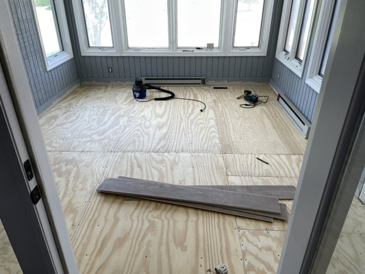 Sunroom flooring replacement - This sunroom had old carpet that needed to be replaced. The homeowner decided she wanted something different. Luxury vinyl planking is a good solution because it is waterproof.