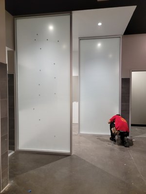 Decorative Frost Film on Mesa EOS to create privacy at the Men and Women bathroom entrances, Frost film gives the ellagance of Frosted Glass - We have successfully completed several installations of Frost film for EOS through various General Contractors. We have completed over a half dozen EOS since 2016. The entrance glass pictured is 10' high!
We also apply film in between the toilet area and shower area. On many EOS we have applied film on the pool area and entrance from the gym to the Pool area.
The installations usually take less than a day. When installing the big 10' windows we use 2 installers to guarantee a proper install done safely.
Frost film are available in hundreds of choices, this is a Light basic frost. It allows in 70% of the light but still provides adequate privacy. Frost films are a fraction of the cost of Factory etched or frosted glass, and when indoors they will last decades!
We use films like these frequently on entrances to building, bathroom window, conference rooms and sidelites in offices. Decorative Frost Film on Mesa EOS to create privacy at the Men and Women bathroom entrances, Frost film gives the ellagance of Frosted Glass - We have successfully completed several installations of Frost film for EOS through various General Contractors. We have completed over a half dozen EOS since 2016. The entrance glass pictured is 10' high!
We also apply film in between the toilet area and shower area. On many EOS we have applied film on the pool area and entrance from the gym to the Pool area.
The installations usually take less than a day. When installing the big 10' windows we use 2 installers to guarantee a proper install done safely.
Frost film are available in hundreds of choices, this is a Light basic frost. It allows in 70% of the light but still provides adequate privacy. Frost films are a fraction of the cost of Factory etched or frosted glass, and when indoors they will last decades!
We use films like these frequently on entrances to building, bathroom window, conference rooms and sidelites in offices.