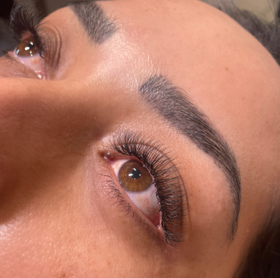 Hybrid Lashes - A Hybrid lash set is the perfect blend of Classic and Volume lashes, combining the natural look of single extensions with the fullness of handmade volume fans. This creates a soft, textured, and wispy effect that enhances your eyes without looking overly dramatic. Ideal for those who want a little more volume than Classic, but not as bold as a full Volume set—Hybrid lashes offer the best of both worlds! Hybrid Lashes - A Hybrid lash set is the perfect blend of Classic and Volume lashes, combining the natural look of single extensions with the fullness of handmade volume fans. This creates a soft, textured, and wispy effect that enhances your eyes without looking overly dramatic. Ideal for those who want a little more volume than Classic, but not as bold as a full Volume set—Hybrid lashes offer the best of both worlds!