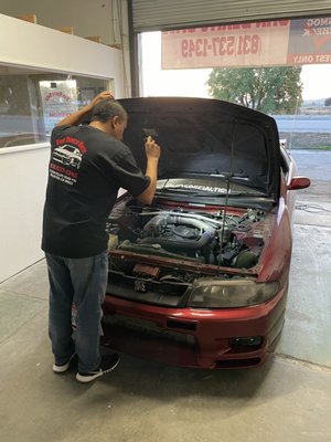 Smog Check - San Benito Smog works on every year vehicle needing emissions testing. From 1976 to present year vehicles, Hollister's newest smog shop is ready to make your DMV registration/renewal process one step easier. Here we have on of our two technicians performing a visual inspection required by the state of California to finish up the Smog Check and get our satisfied customers on their way. Smog Check - San Benito Smog works on every year vehicle needing emissions testing. From 1976 to present year vehicles, Hollister's newest smog shop is ready to make your DMV registration/renewal process one step easier. Here we have on of our two technicians performing a visual inspection required by the state of California to finish up the Smog Check and get our satisfied customers on their way.