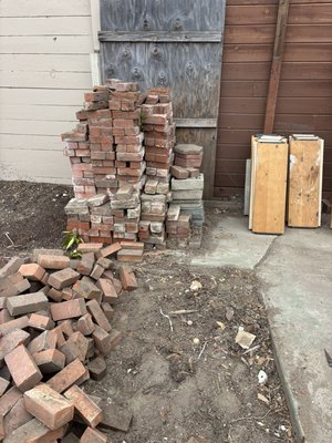 2 day Junk Removal - The first day, the customer wanted this piles of wood and debris, cement, and a jacuzzi that was about 6’ by 6’ {ft} junked. The second day we are removing all the little bricks piled up in the picture !