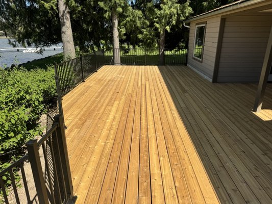 Custom Cedar Deck with Black Aluminum Railing - This custom cedar deck was built with new framing, premium cedar decking, and durable black aluminum railings for a clean, modern finish. The project also included deck skirting, ducting, and vent integration to ensure a polished appearance and long lasting performance.
