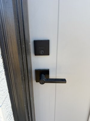 Lock installation with dark bronze color - New locks installed keyless entry handle set and deadbolt Lock installation with dark bronze color - New locks installed keyless entry handle set and deadbolt