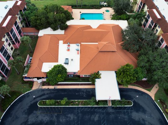 Embark of Lake Worth - This Senior Living Facility contacted us regarding several leaks coming from several of the flat roofs, on multiple buildings, as well as the tile roof on the main facility building. The two main residential buildings were in need of a flat roof replacement, while the main facility building and pool house were in need of both flat roof and tile roof replacements.