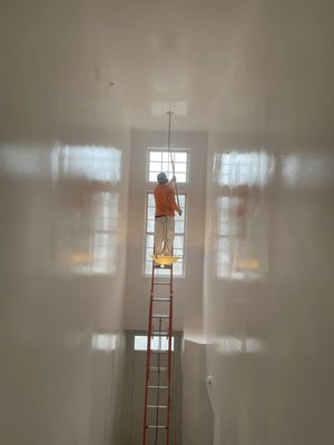 Painting at New Heights - Humidty and spray-painting are a bad combination! To prevent any dripping, sometimes you need to climb up the ladder to paint walls with high ceilings.