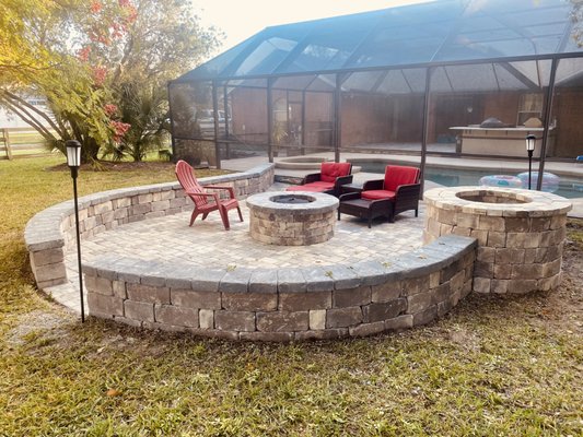 Outdoor Patio w/ Firepit - This couple wanted to transform an unused area outside their pool to an entertainment space, so they called the Paver Kings to see what we could do. We built this beautiful patio with perimeter seating, firepit, and custom table around their old well. We were done in no time and they are already enjoying the fall weather outside! Outdoor Patio w/ Firepit - This couple wanted to transform an unused area outside their pool to an entertainment space, so they called the Paver Kings to see what we could do. We built this beautiful patio with perimeter seating, firepit, and custom table around their old well. We were done in no time and they are already enjoying the fall weather outside!