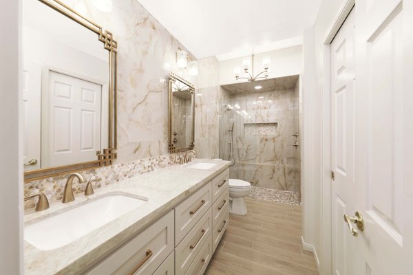 Stockdale Country Club Bathroom Remodel - This remodel was done for an 80's built bathroom. We opened the space by removing the wall between the vanity and shower. With the beautiful onyx tile and champaign gold hardware we created a design that turned this small space to the luxurious bathroom our client desired.