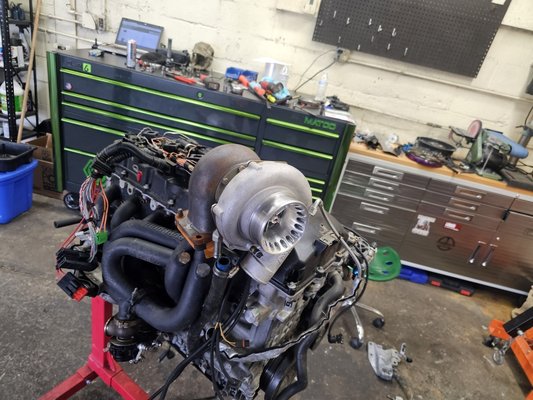 E90 1100hp N54 Project - This car came in wrecked, and not running. The entire drive train was removed and installed into the new shell. Then a bunch of updated were made including a new fuel system, custom catch can, power steering reservoir, and coolant overflow. Also we added a custom fender exit exhaust system.