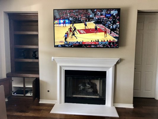 TV over fireplace - This TV over fireplace installation with wire concealment and cable box secured behind TV TV over fireplace - This TV over fireplace installation with wire concealment and cable box secured behind TV